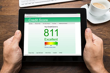a person checks their credit score on a tablet